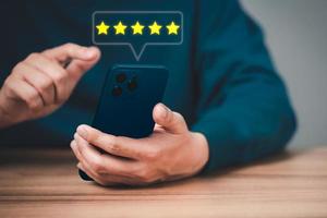 Man using a smartphone in give rating to service experience on application. Online customer review satisfaction feedback survey and testimonial. photo