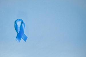 blue ribbon awareness World diabetes day,14 november. isolated on a blue background. Copy space. Top view photo