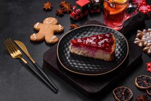 Homemade tasty cheesecake with jelly and raspberry berries on a black plate photo