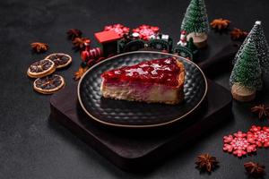 Homemade tasty cheesecake with jelly and raspberry berries on a black plate photo