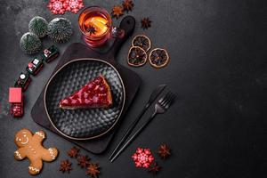 Homemade tasty cheesecake with jelly and raspberry berries on a black plate photo