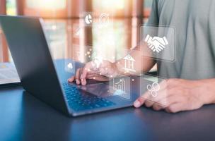 Business people work through laptops, virtual icons representing big data concepts, cyberspace technology and internet network databases, innovative connections and communications around the world. photo
