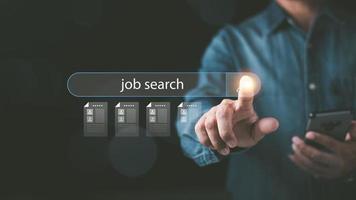 man pointing at icon Displays online job search information, career search ideas, recruitment, HR search, form websites and job applications,employment management of agencies with Internet technology photo