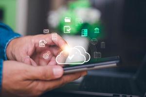 Human hand touches the smartphone, the concept of transferring, uploading, and downloading data, cloud computing technology transformation, online storage, large data backup and transmission. photo