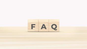 Wood blocks with word FAQ on wooden table. Frequently asked question concept. 3D illustration. photo