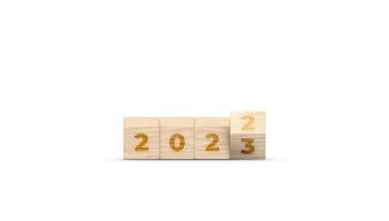 Flipping the 2022 to 2023 year numbers calendar on wooden cube blocks for new year change, starting new things or new business. 2023 happy new year concept banner. 3D illustration. photo