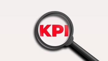 KPI word lettering typography with magnifying glass zooming the word KPI on white background. 3D illustration. photo