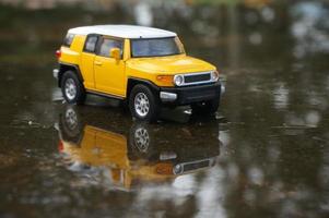 East Kutai, East Kalimantan, Indonesia, 2022 - Yellow car toys on the rood photo with nature background