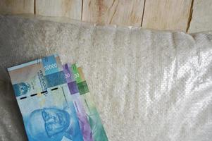 Sack of rice and indonesian money. photo