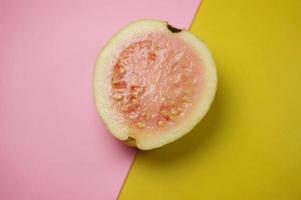 Guava fruit  on pink and yellow background with selective focus. photo