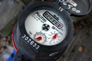 East Kutai, East Kalimantan, Indonesia, 2021 - Closeup of  Water meter with selective focus , Measuring device, Open cover of water meter to check counter number of water consumption photo