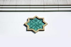 Detail Islamic Ornament on white wall mosque. photo