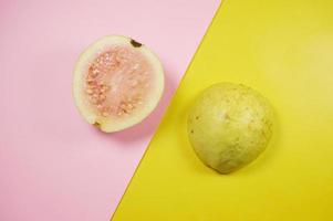 Guava fruit  on pink and yellow background with selective focus. photo