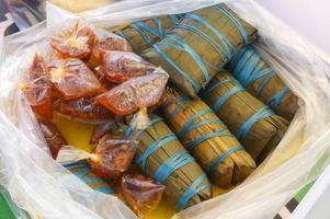 Burasa or buras is a type of Indonesian rice dumpling, originating from Indonesia, cooked with coconut milk packed inside a banana leaf pouch. photo