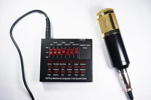 East Kalimantan, Indonesia, 2020 - V8 Audio Soundcard and gold Condensor Microphone isolated on white background photo