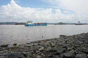 Samarinda, East Kalimantan, Indonesia , 2022 - Coal transporting barges neatly lined up in Mahakam river with selective focus photo