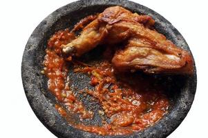 Sambal ulek terasi or Fried chicken and chili shrimp paste sauce with selective focus. photo