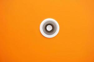 White lamp on the top of roof orange background. photo