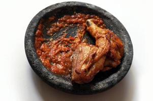Sambal ulek terasi, Fried chicken and chili shrimp paste sauce with selective focus. photo