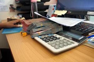 Sangatta, East Kalimantan, Indonesia, 2020 - Money indonesian Rupiah Bank notes, Indonesian Currency.  Money Indonesian rupiah on work desk in the office photo