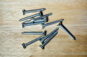 long screws on wood table photo