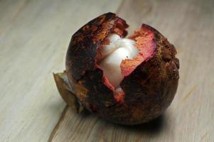 Mangosteen peeled on wood table. Mangosteen queen of fruit. photo