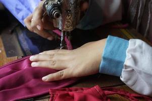 Woman making protective fabric masks at home. Selective Focus. photo