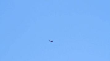 Jet airplane cutting across a clear blue sky background. video