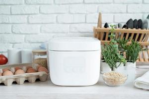 Electric rice cooker on wooden counter-top in the kitchen