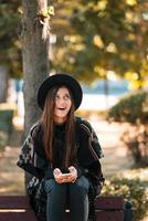 Young woman on a bench in the autumn park photo