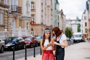 two young women walking outdoor having fun photo