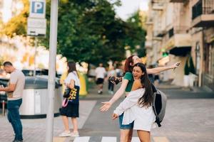 Happy meeting of two friends hugging in the street photo