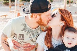 Parents spend time with their son on the beach photo