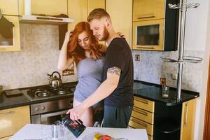 Happy pregnant family with fresh fruit photo