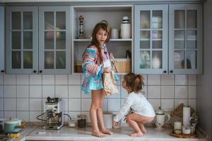 two little girls are looking for cookies photo