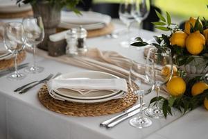 Festive table at the wedding party decorated with lemon arrangements photo