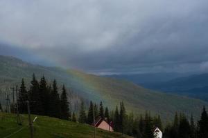 Rainbow over mountain peak photo