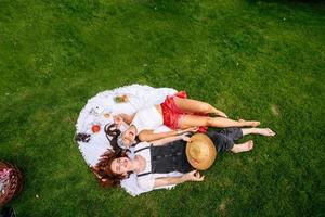 Top view, two young women lying in the park photo