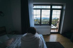 Young woman wrapped in a blanket staring into the distance photo
