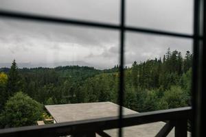 View of the mountain forest through the window photo