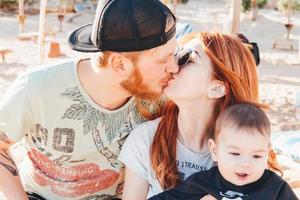 Parents spend time with their son on the beach photo