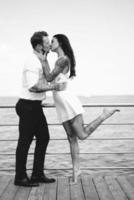 Guy and girl on the sea pier photo