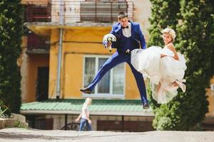 couple jumping on the street photo