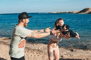 Parents playing with their little son photo