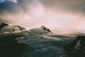 landscape with clouds and snowed mountains photo