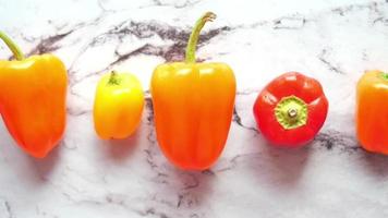 Multi Colored bell peppers on marble countertop video