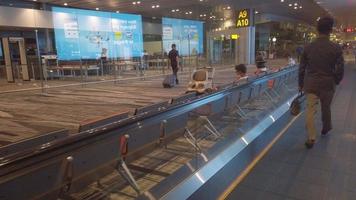 Airport interior with people seated waiting near a moving walkway video