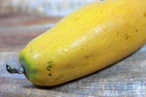 Ripe papaya isolated on a wooden background photo