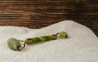 Jade roller on a white towel photo