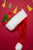 New Year and Christmas decorations on red background, flat lay. Concept of greeting card for holidays photo